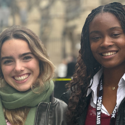 Bite Back activists Alice and Jayda are stood outside the Houses of Parliament smiling