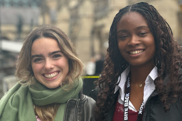 Bite Back activists Alice and Jayda are stood outside the Houses of Parliament smiling