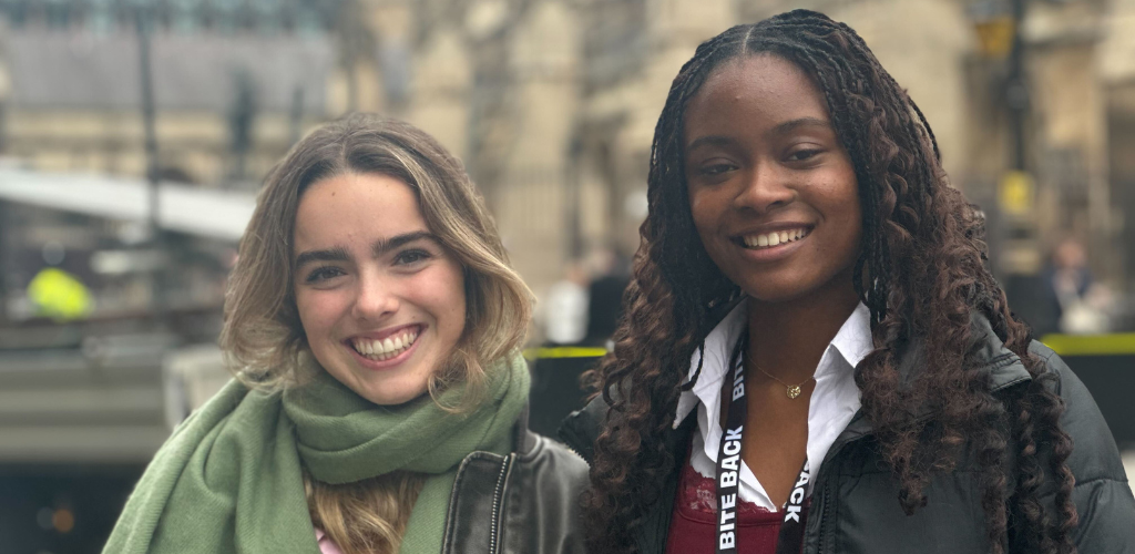 Bite Back activists Alice and Jayda are stood outside the Houses of Parliament smiling